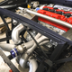 A custom fabricated turbo inlet manifold bolted to a Honda K24 engine.